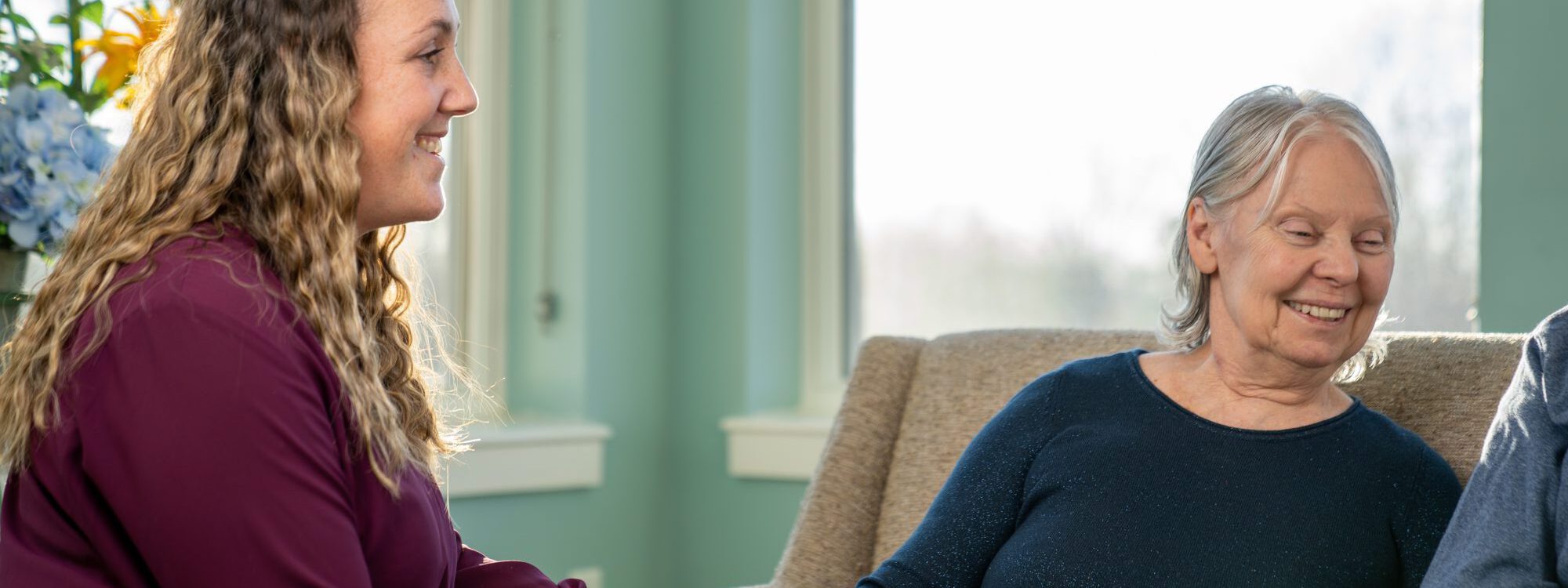 Lutheran Life Villages Family A resident of Lutheran Life Villages smiling and enjoying company